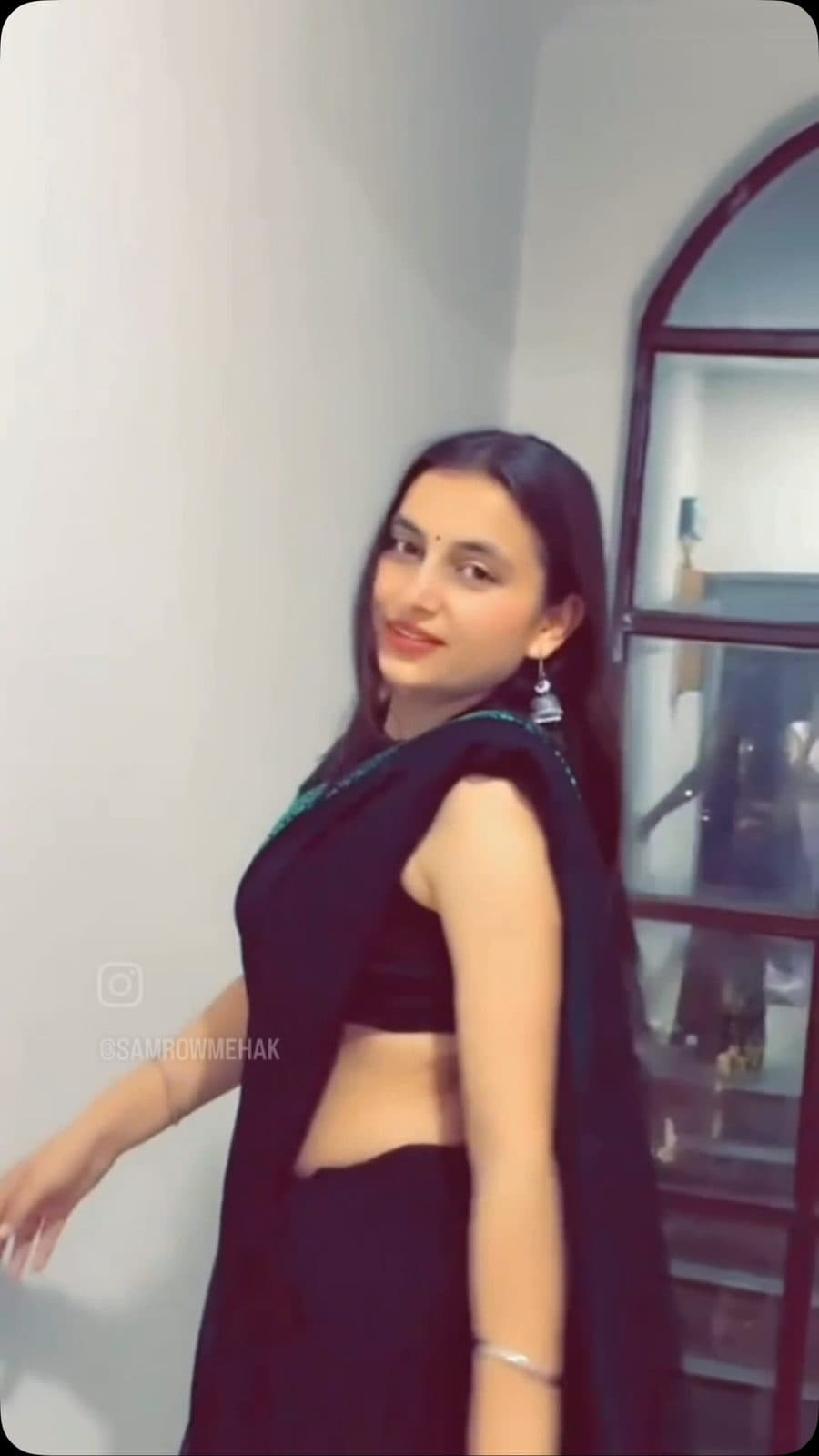 Aishwanee House black saree draped at home