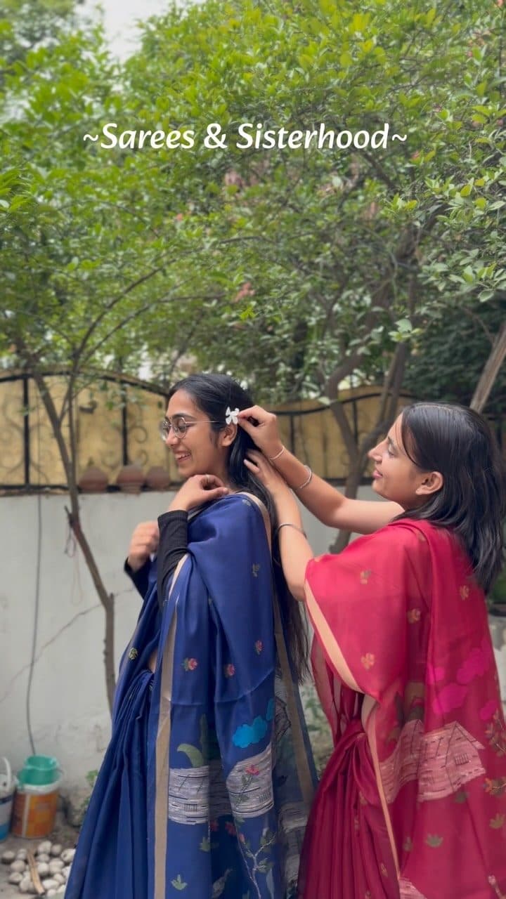 Two friends helping each other drape Aishwanee House sarees at home